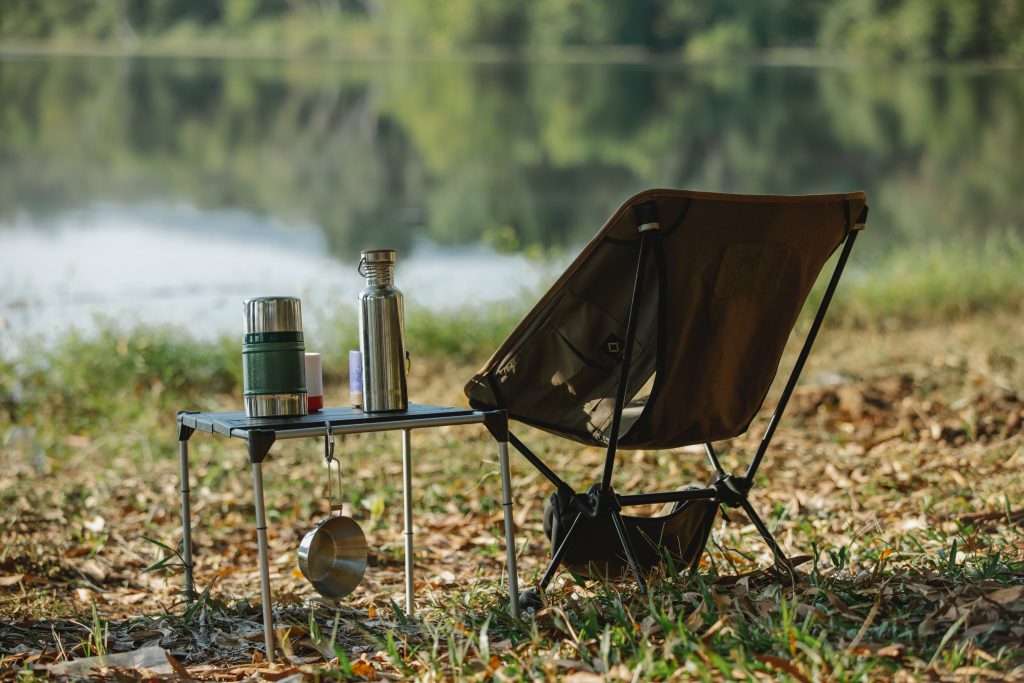 A camp chair facing a lake 